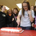 Bentonville’s Whittley Johnson cuts a cake Friday after signing to play softball for Lyon College in...