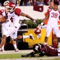 Arkansas wide receiver Jarius Wright breaks away from the outstretched arms of Mississippi State def...