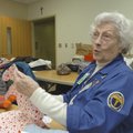Charlotte Horvath demonstrates how she cuts the pieces for the cloth bears volunteers make for child...