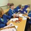 Erlene Robertson, from left, Marilyn Rader and Mary Lou Anderson make gift boxes at the hospital.