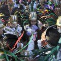 The Aztec dancers from St. Vincent de Paul Catholic Church in Rogers gather together Sunday during a...