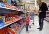 Anistyn Woods, 2, of Fayetteville checks out the toys Thursday with her mother, Jessica King, at the Wal-Mart store on Mall Avenue in Fayetteville.