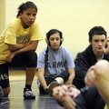Bentonville’s Sheyenne Walker, 17, left, and Bianca Dover, 14, watch as assistant coach Sherril Neal...