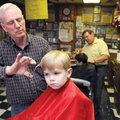 Gary Townzen gives Jonah Cotton, 3, of Bella Vista a free haircut Saturday at Townzen’s Barber Shop ...