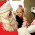 SANTA VISITS Tabitha Lantz, 3, watches as Santa reads a letter Saturday she wrote to him saying what...