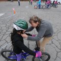 Laura Kelly helps Alejandra Murguia, 11, adjust her bike helmet Wednesday at Leverett Elementary Sch...