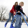 Claire O’Dell, 9, of Bentonville helps her friend Brooks Burleson, 4, of Rogers ice skate Tuesday du...
