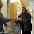 Marvin Schrimpf, a representative of United Lutheran Church of Bella Vista, presents Tanya Castaneda...