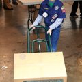 Samuel Pitts, 9, a Bentonville Cub Scout from Pack 136, helps move one of 600 boxes of food for Chri...