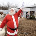 Robert Harris of Fayetteville waves at passing cars Friday while working for the owners of Fayettevi...