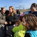SEASONAL SURPRISE - Sierra Weaver of Mobile, Ala., left, is greeted Thursday by her father’s girlfri...