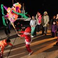 Children laugh while collecting candy from a pinata during the Las Posadas celebration Tuesday at a ...