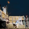 Mary and Joseph adore the newborn Jesus in a living Nativity scene in front of the First United Meth...