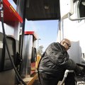 Vincent Chatman, a truck driver with P.A.M. Transportion Services, pumps diesel Thursday at the Pilo...
