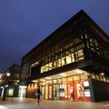 A pedestrian walks past the Garland Center on Tuesday on the University of Arkansas campus which is ...