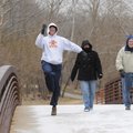  Vince Sheahan, from left, shows his spirit of the season while walking with Terri Sheahan and J.C. ...