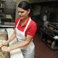  Anyela Deybi Mendoza makes a pupusa on Dec. 3 at Deybi’s Restaurante Salvadoreño on Huntsville Aven...