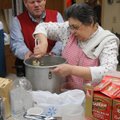  Grace Grame stirs a pot of stuffing with help from Biff Averitt for Christmas dinner at Central Uni...