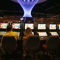 Patrons watch the screens on gaming machines inside the Downstream Casino in northeast Oklahoma. Tri...