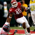 Arkansas tight end D.J. Williams tries to break away from Ole Miss safety Fon Ingram during the thir...