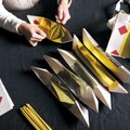 Nou Lee of Lincoln demonstrates Wednesday, Dec. 8, 2010, how spiritual "money" is folded in a tradit...