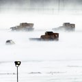Snow removal crews work to clear runways at Philadelphia International Airport in Philadelphia, Mond...
