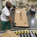 In this Nov. 11, 2010 photo, Leacroft Green places a package to the correct shipping area at an Amaz...