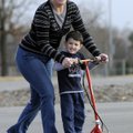 SCOOTING AROUND Roneen Brooksby and her son Wyatt, 3, enjoy a ride on a motorized scooter Thursday a...