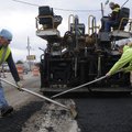 PATCH IT UP  Workers with Hutchens Construction of Cassville, Mo., patch the asphalt Thursday remove...