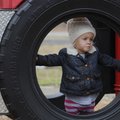 PLAYTIME IN THE PARK  Ryan Livergood, 2, of Santa Barbara, Calif., looks out from a tire Thursday at...