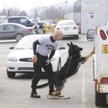 Morris Irvin, Springdale police officer, watches as police dog Xato finds narcotics Dec. 21 during a...