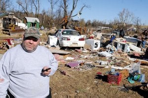 Richard Grubbs looks through debris Saturday surrounding the house he and his mother, Ruth Mauch, were living in when it was destroyed by the tornado that ripped through the Cincinnati community Friday morning. Grubbs’ grandmother Mamie Wilson and husband Buck Wilson were killed by the storm.