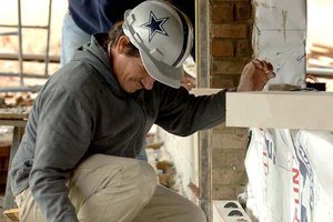Jose Sibrian, with Vratsinas Construction Co., grouts a wall Thursday at a new building under construction at the Arkansas Juvenile Assessment and Treatment Center in Alexander. 