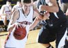 Rogers Heritage’s Thomas Moreland drives the ball as Bentonville’s Bo Weber defends during the Neosho (Mo.) Holiday Classic on Dec. 30.