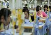 Workers sew shirts last month at the Lever Style Inc. factory in Shenzhen, China, as clothing prices soar in the Asian nation. 