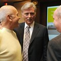 Gov. Mike Beebe, center, talks with John Tyson, left, and Beebe’s assistant Jon Moran before the sta...
