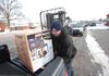 Craig Moore loads a generator into a truck at a Muncie, Ind., store that sold more than 200 units Monday.
