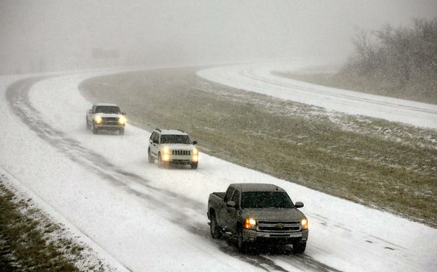 vehicles-travel-on-a-snow-covered-roadway-in-northwest-arkansas-on-tuesday-feb-1-2011