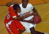 Little Rock Hall’s Bobby Portis (right) drives to the basket against Marion’s Keenan Anderson during the Warriors’ 63-49 victory over the Patriots on Tuesday in Little Rock.