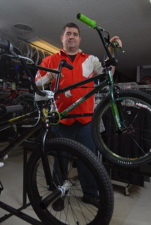 Shawn Basinger shows off some of the BMX bikes at Basinger Bikes in Cabot.