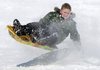 CATCHING AIR Jasper Terry, 9, catches some air off a snow ramp Thursday while sledding with friends at Lingle Middle School in Rogers. The hillside on the south side of the school has been a popular sledding spot for children and adults since Tuesday’s winter storm dumped several inches of snow on Northwest Arkansas.