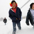 Terrell Palmer, 13, center, and Casen Hutcheson, 14, trudge through knee deep snow early Wednesday, ...