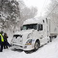 Shambu Geleta, left, and Zerihun Negari, both of Denver, stand outside their semi truck Wednesday, F...