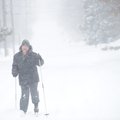  Sean Dempsey of Fayetteville makes his way east on East Maple Street Wednesday, Feb. 9, 2011, on a ...
