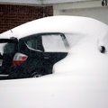 Snow covers a car in Lowell Wednesday.