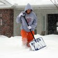 Jamie Bowen shovels snow in front of her Lowell home on Wednesday, Feb. 9, 2011.