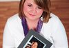 Alicia Elmore holds a photo of her father in this image taken for the Relay for Life, the American Cancer Society’s signature fundraiser. Elmore has been active in the Washington County Relay event since her father’s diagnosis.