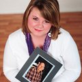 Alicia Elmore holds a photo of her father in this image taken for the Relay for Life, the American C...