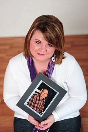 Alicia Elmore holds a photo of her father in this image taken for the Relay for Life, the American Cancer Society’s signature fundraiser. Elmore has been active in the Washington County Relay event since her father’s diagnosis.