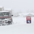 A truck leaves an apartment complex off Lowell Road Wednesday in heavy snow fall.